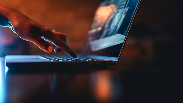 a hand using a laptop