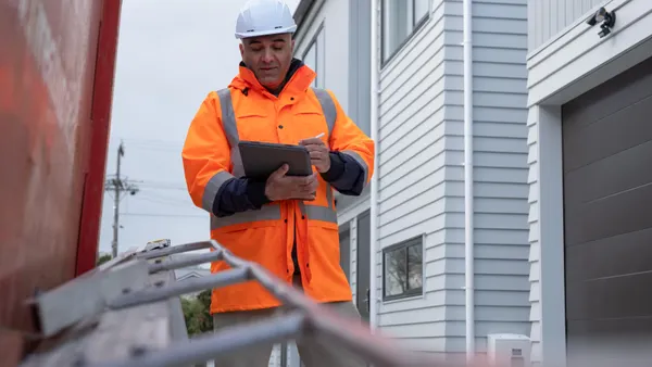 A Site Manager Checking His Reports