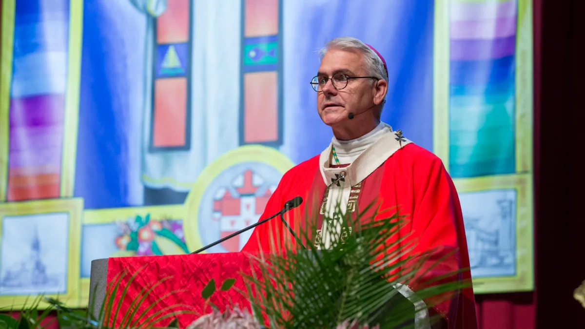 Archbishop Coakley of the Archdiocese of Oklahoma City is shown standing at the pulpit.