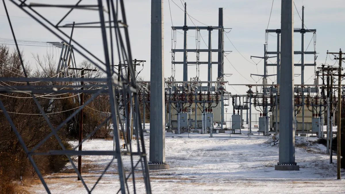 Transmission towers and power lines lead to a substation.