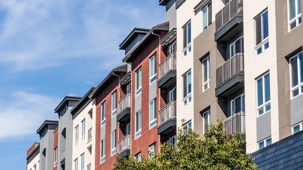 Picture of multi-colored apartment buildings with balconies.