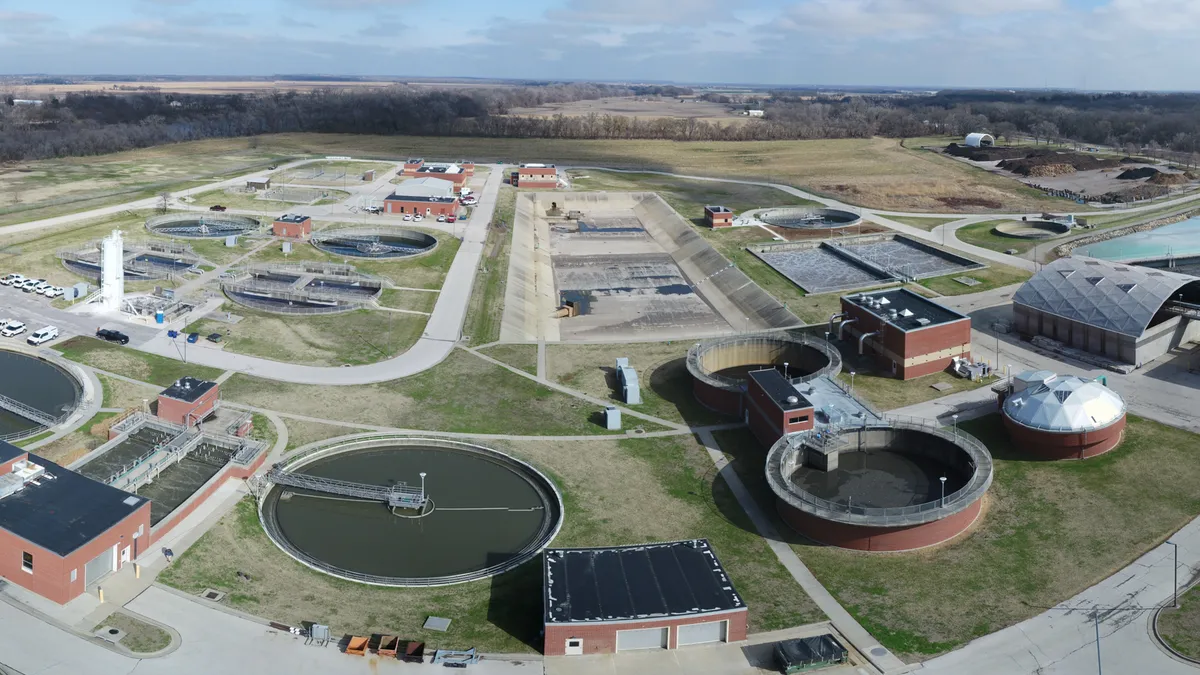 An aerial view of the Kansas River Wastewater Treatment Plant, a collection of buildings surrounded by grass.