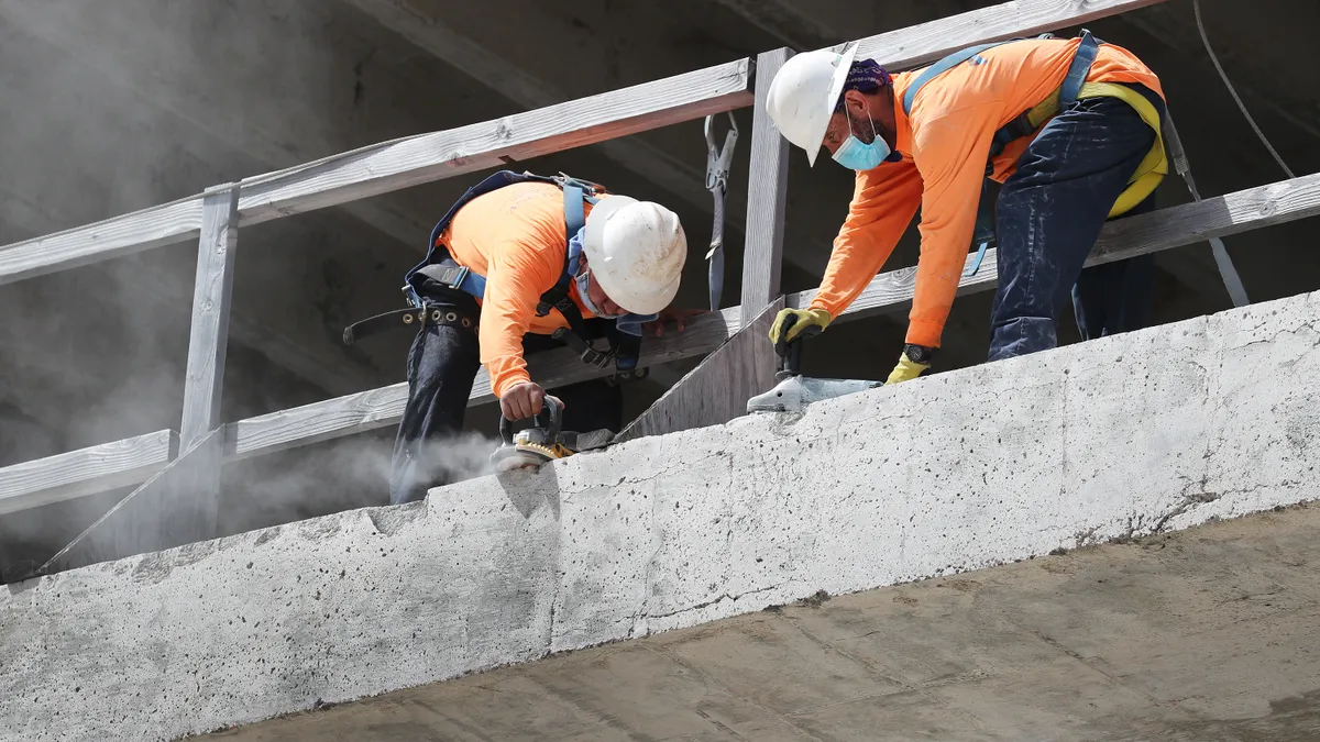 Construction workers with masks working during the COVID-19 pandemic