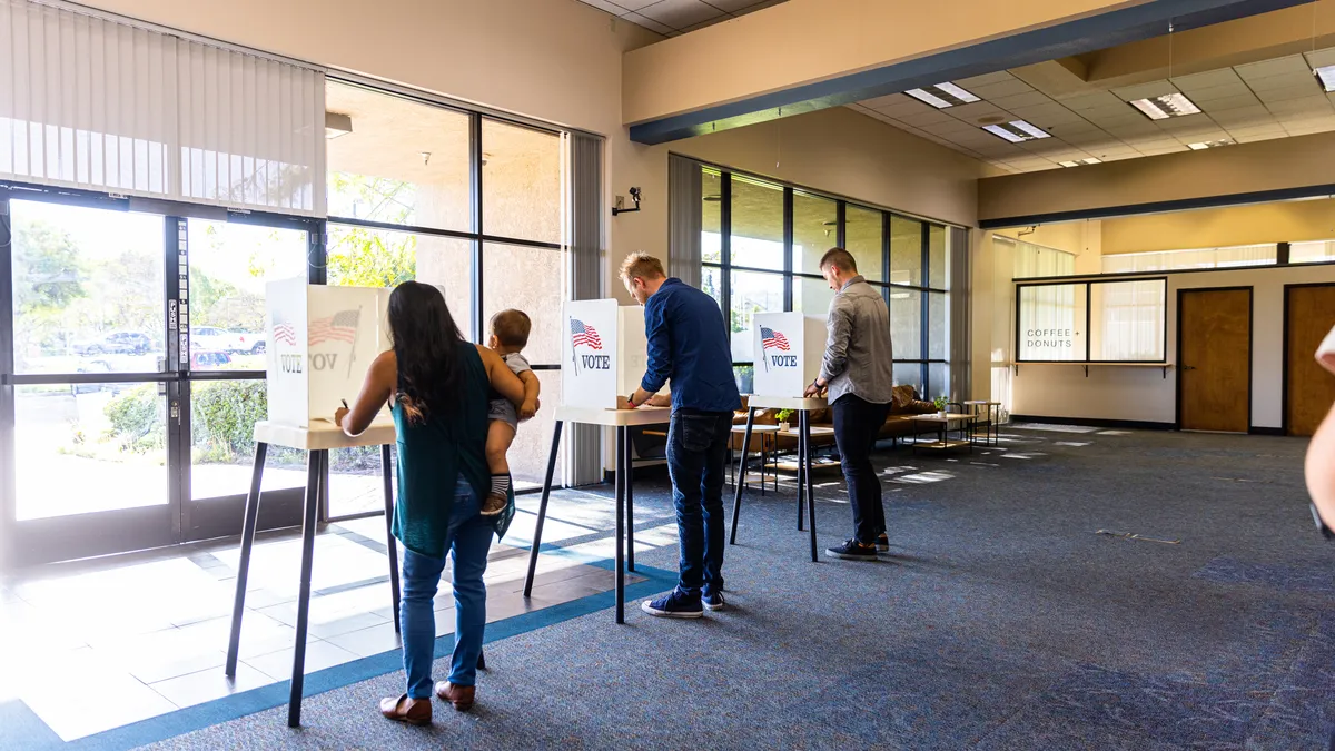 Voters stand to cast their ballots