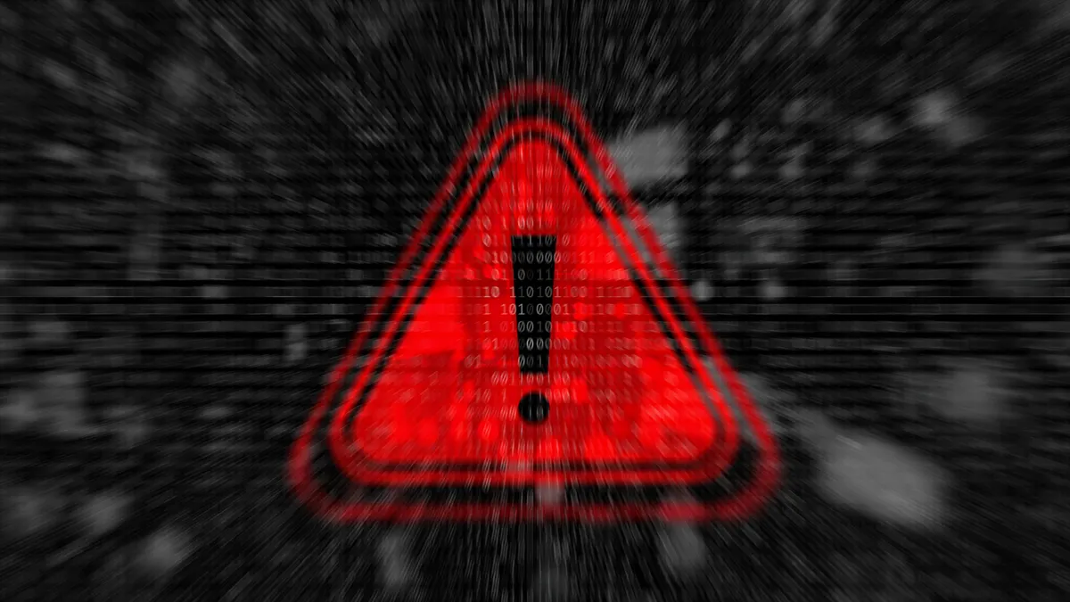 Cybersecurity warning with red warning symbol with binary code