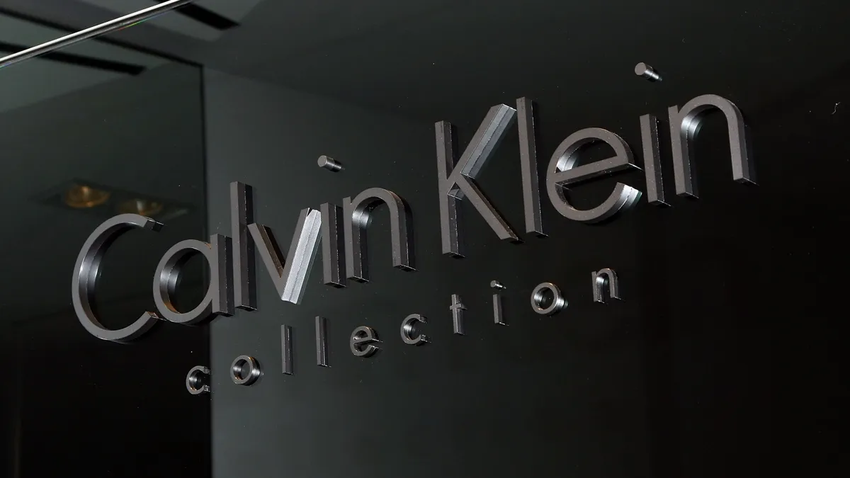 A closeup of a sign in a store reading Calvin Klein Collection.