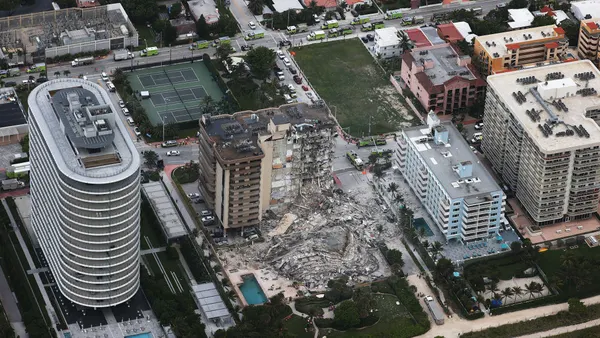 Aerial view of the partly collapsed Champlain Towers South in Surfside, Florida, surrounded by other buildings.