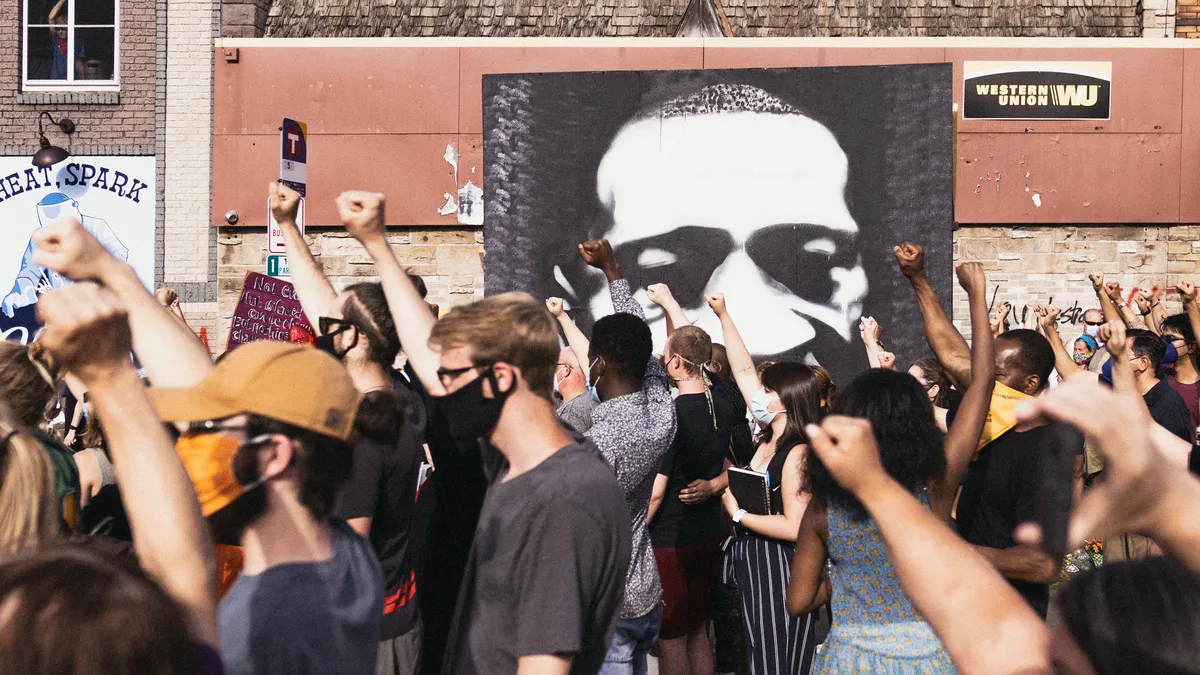 Protestors in front of George Floyd image