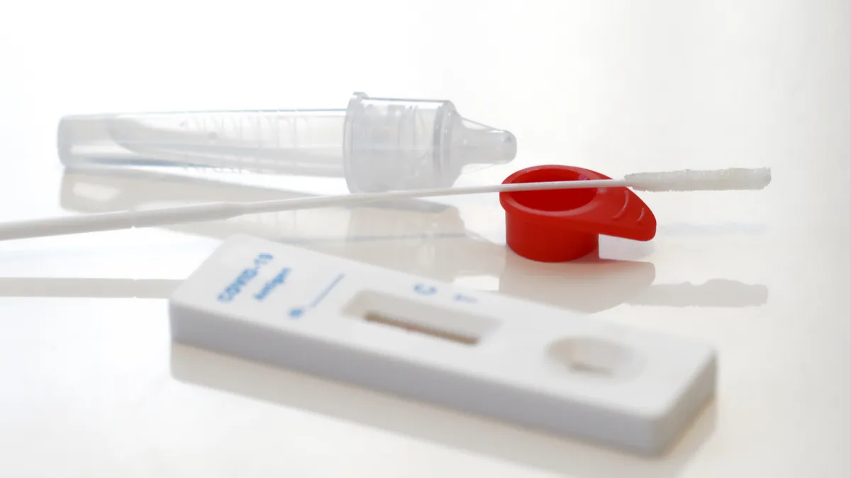 Testing maerials from a COVID-19 nasal self-test kit on a white counter.