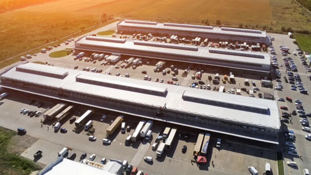 Aerial drone view of a group of large industrial warehouses.