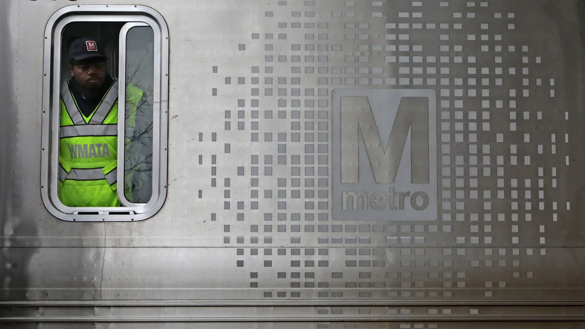 A Metro train conductor checks the platform at the Brookland-Catholic University of America station December 02, 2020 in Washington, DC