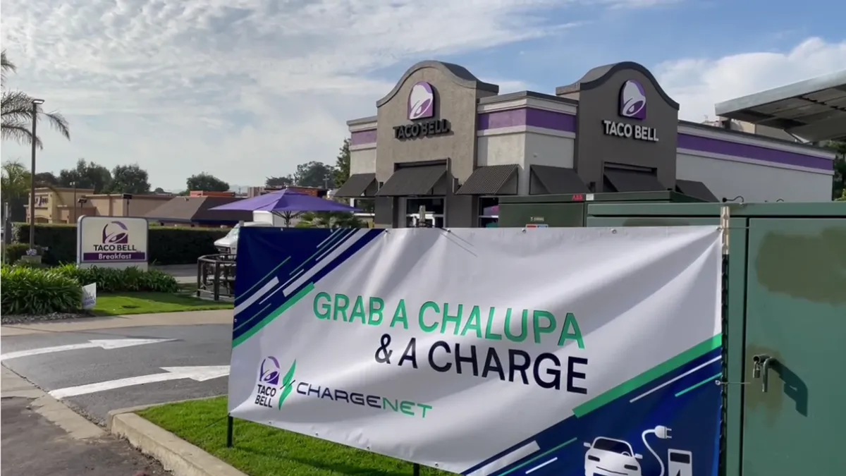 An image of a Taco Bell sign that says "grab a chalupa and a charge."