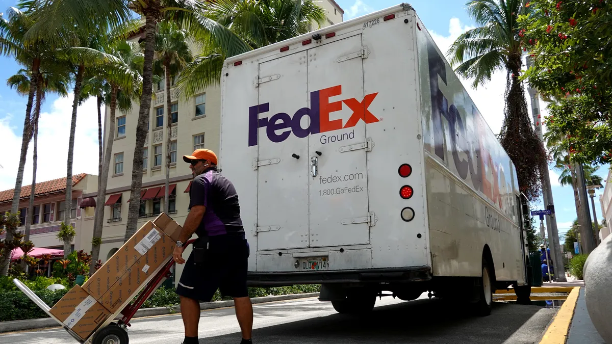 A FedEx employee delivers boxes