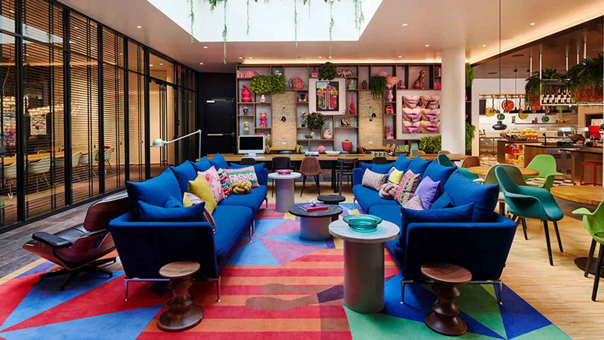 A hotel lobby with colorful furniture.