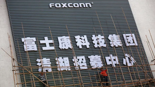 Workers put up scaffolding on a building owned by the contract manufacturer Foxconn International Holdings Ltd on November 28, 2010 in Shenzhen, China.