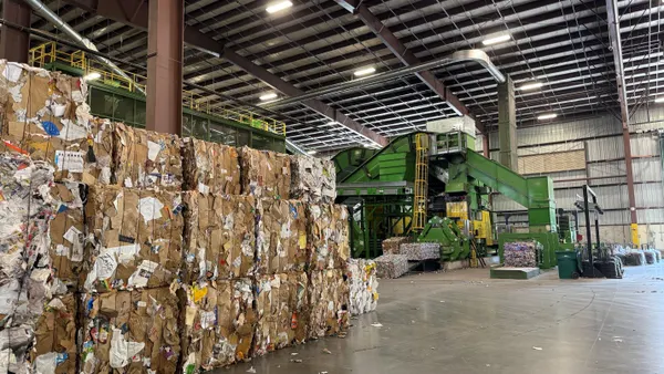 Bales of recycled paper sit in a MRF