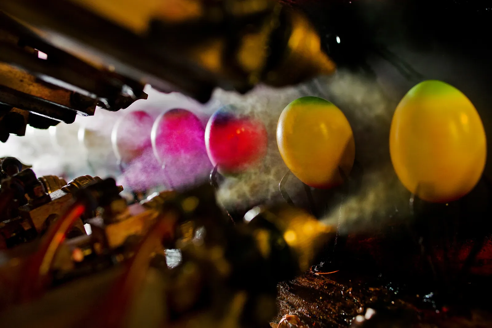 Colorful eggs are sprayed with paint.