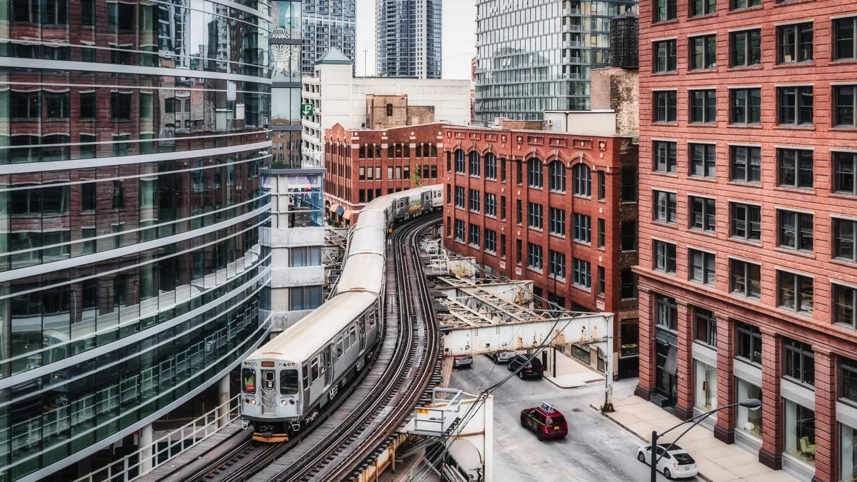 A Chicago elevated train snakes through downtown buildings.