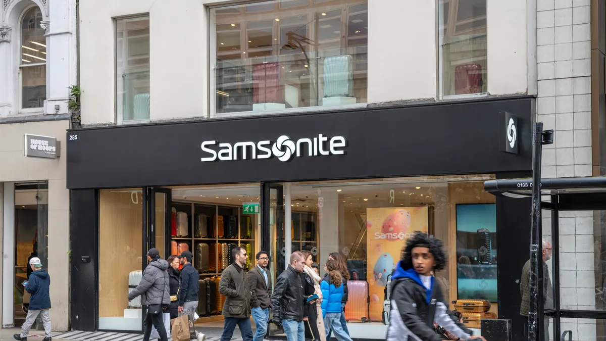 People seen walking in front of Samsonite store.