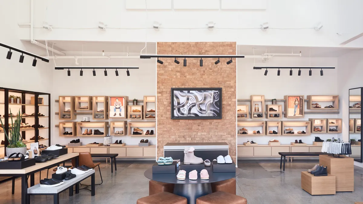 Interior shot a Birkenstock store. Shoes are on shelves, and tables.