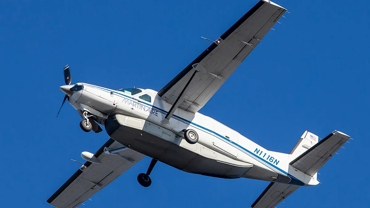 A Martinaire Cessna 208B plane takes flight.