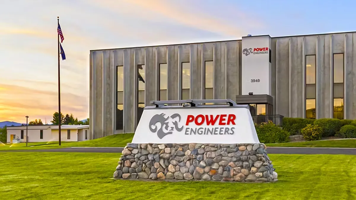 A low grey building with a sign out front that says "power engineers."