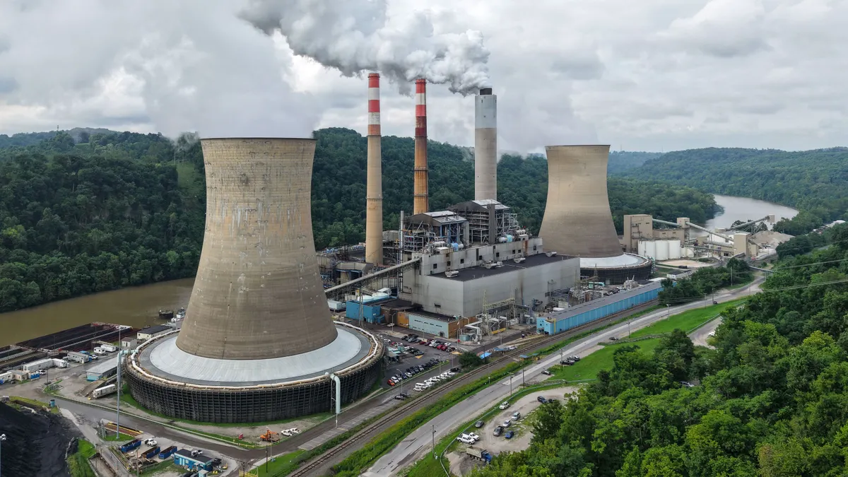 An aerial view of a power plant on a bend in a river.