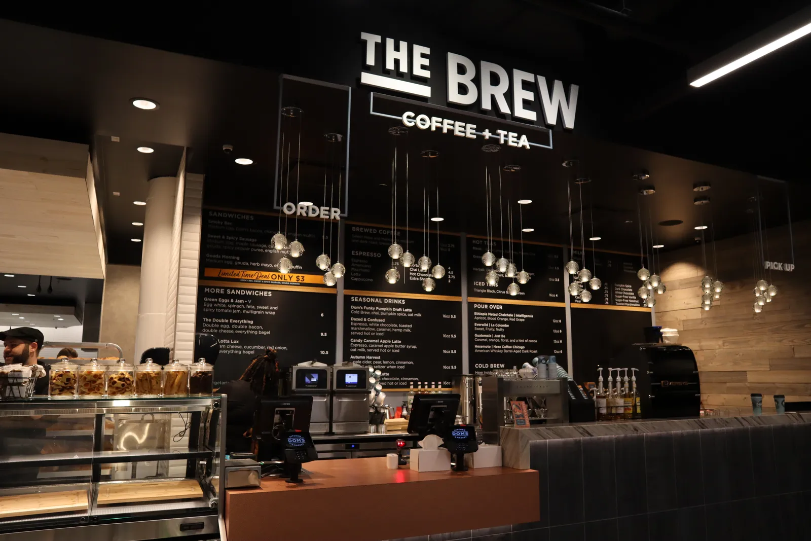 Coffee station inside a store with a sign saying "The Brew"