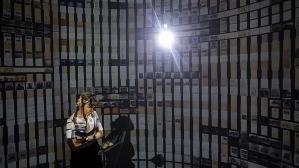 A woman views an art installation created with artificial intelligence.