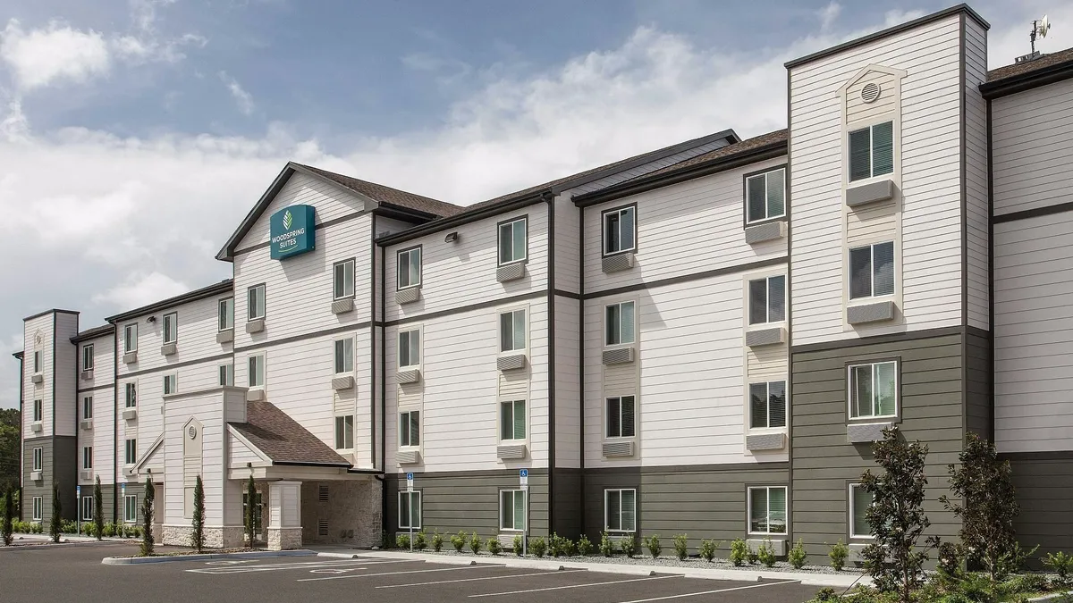 An exterior image of a WoodSpring Suites hotel