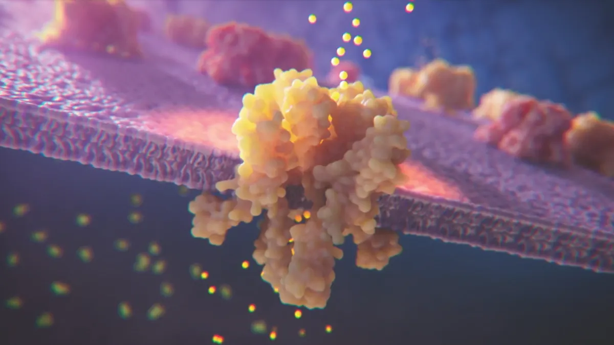 An ion channel, colored yellow, is embedded in a cell membrane in this illustration.