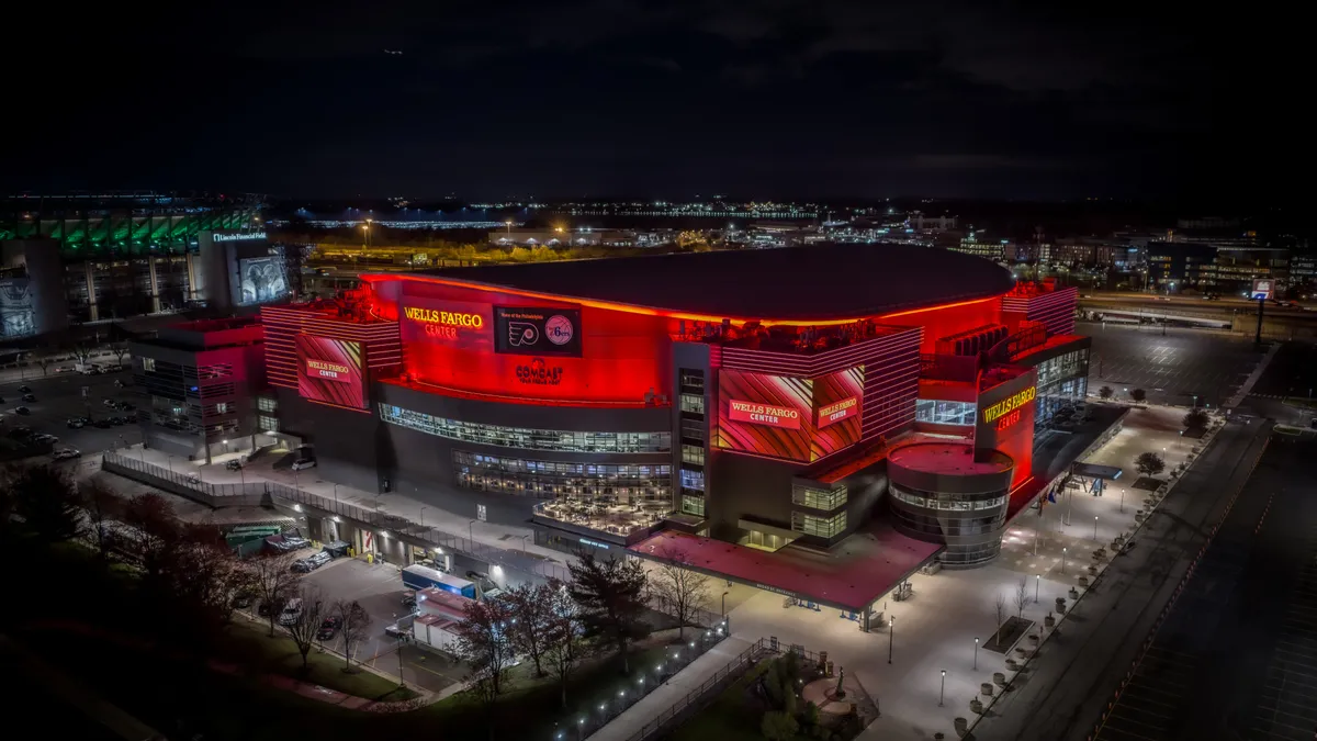 A facade of the Wells Fargo Center in Philadelphia, Pennsylvania seen at night.