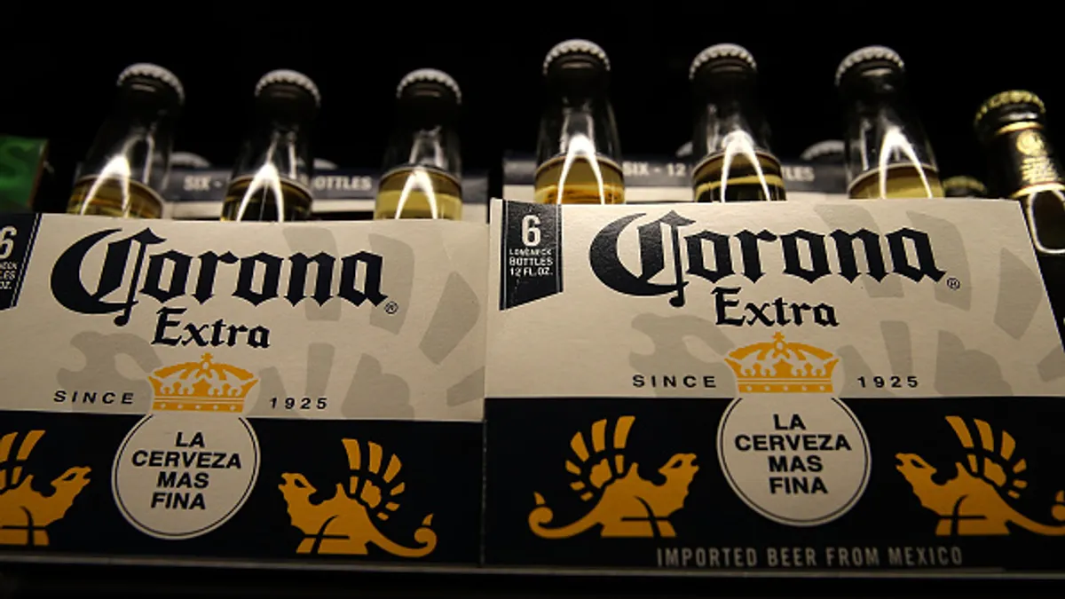 Bottles of Corona beer are displayed on the a shelf at a supermarket.