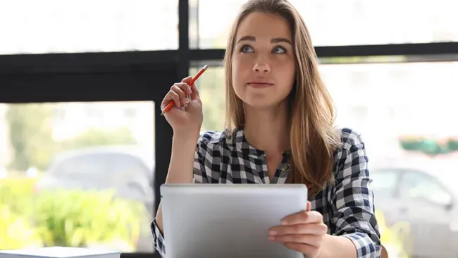 person sitting with pencil in hand