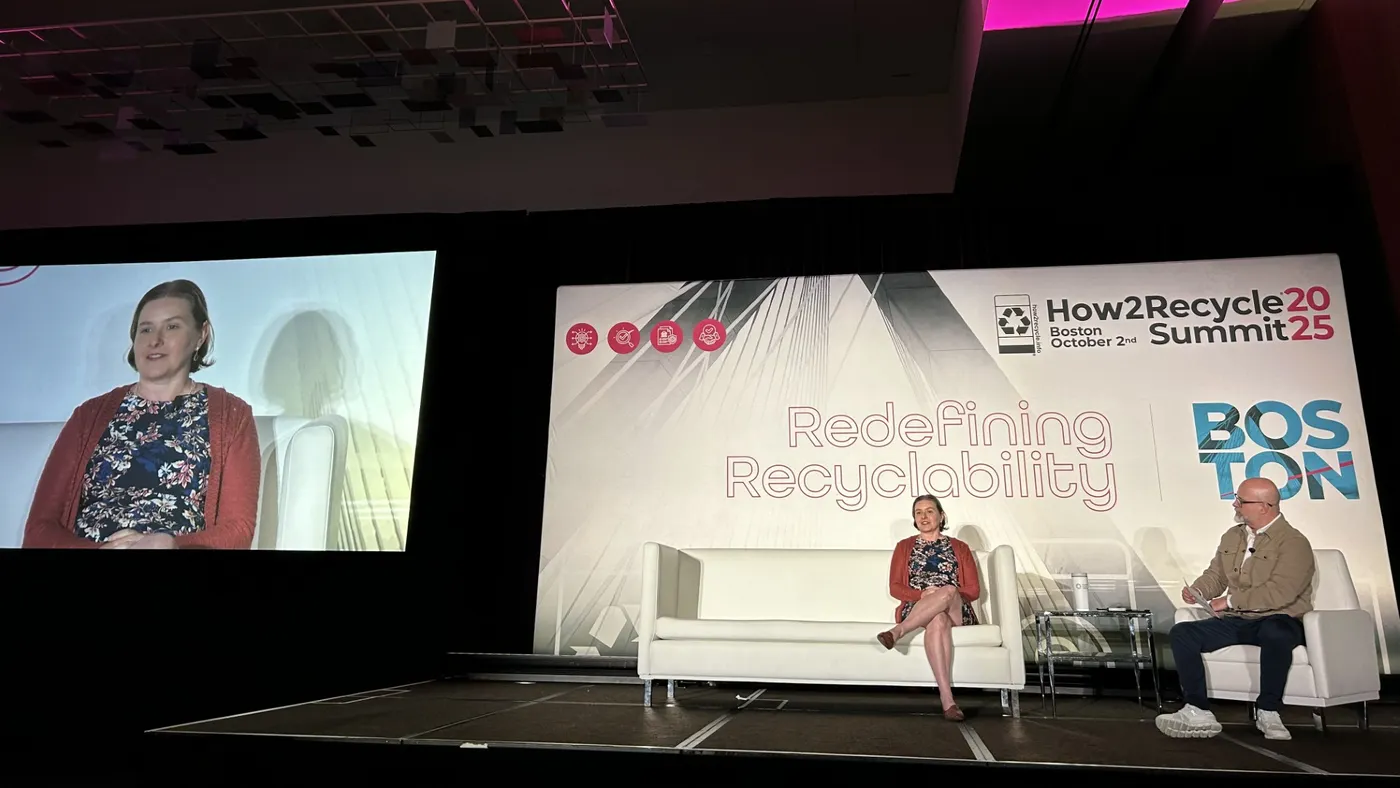 Two people, one from CalRecycle and one from GreenBlue sit on a stage in front of a sign that says How2Recycle Summit 2025