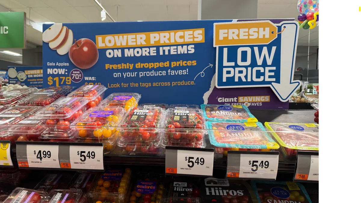 A sign advertising low prices for produce at a grocery store.