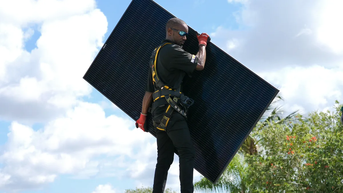 Man carrying solar panel