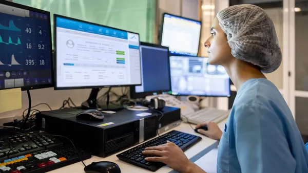 Doctor in the radiology control room and looking at a medical scan