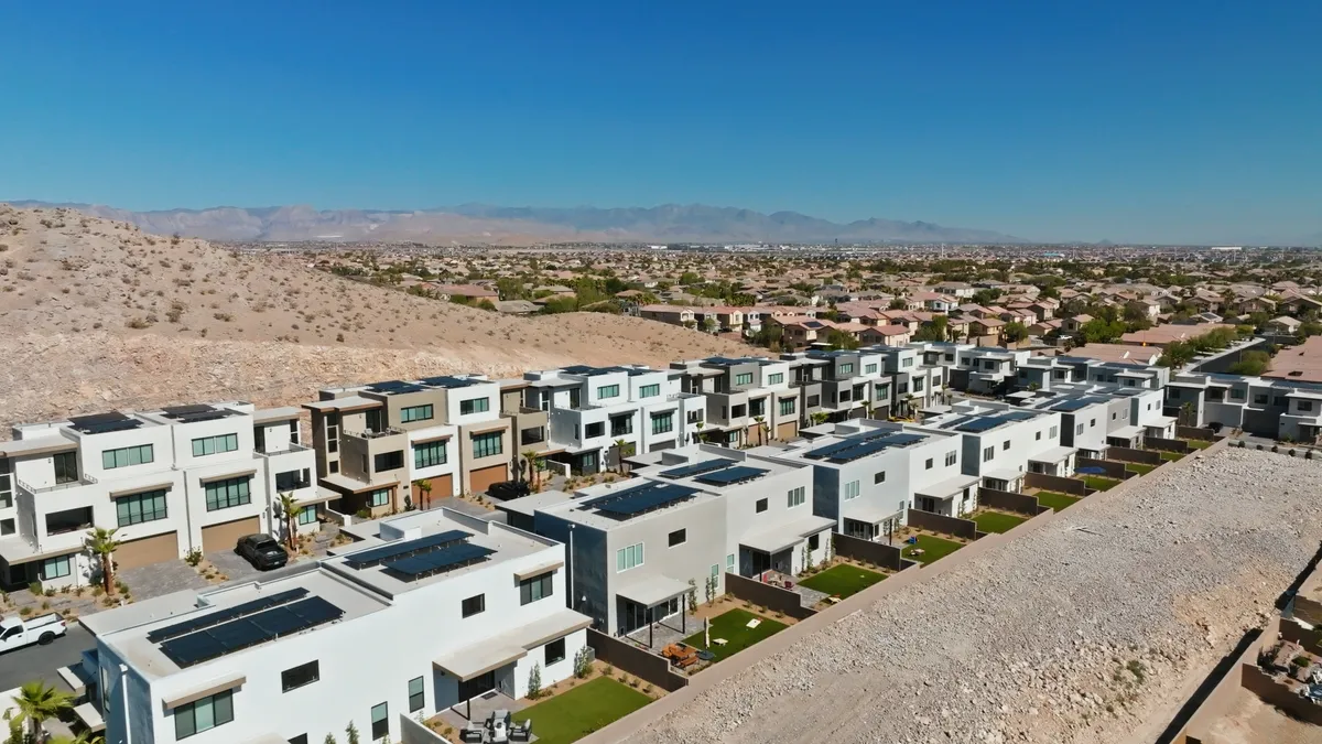 A series of homes at the base of a mountain,