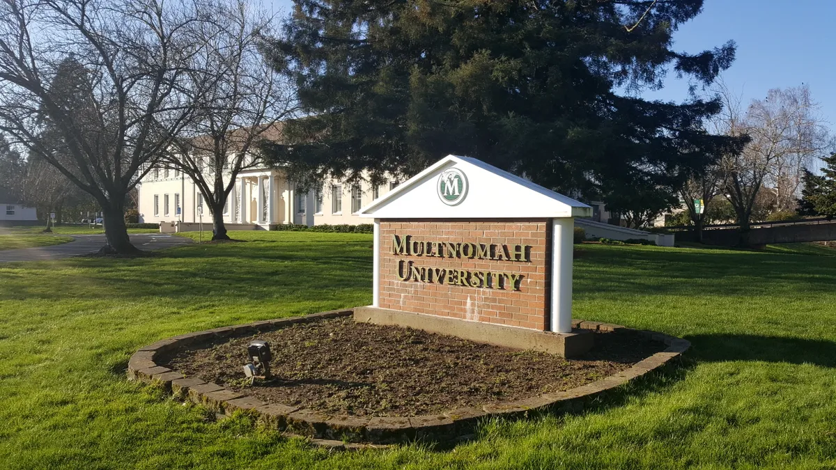 A brick academic sign that reads "Multnomah University"