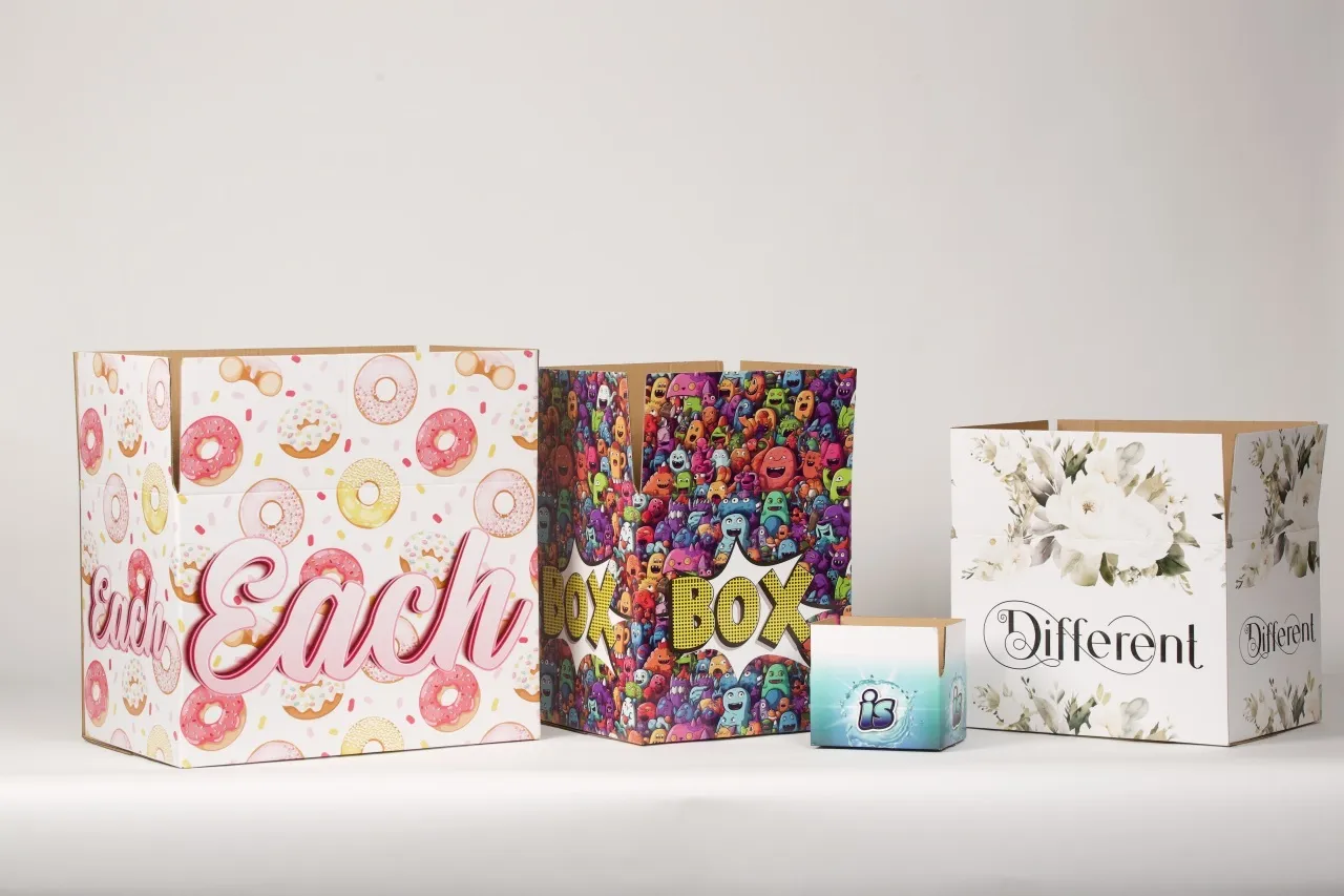 Four cardboard boxes of various sizes with colorful printing on the exterior, each box with different messaging.