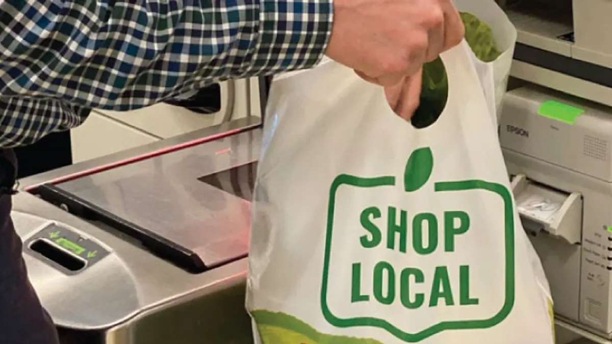 Hand holding plastic bag