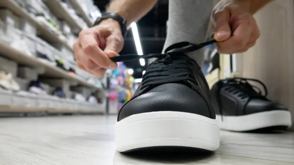 Close up of buyer trying on shoes