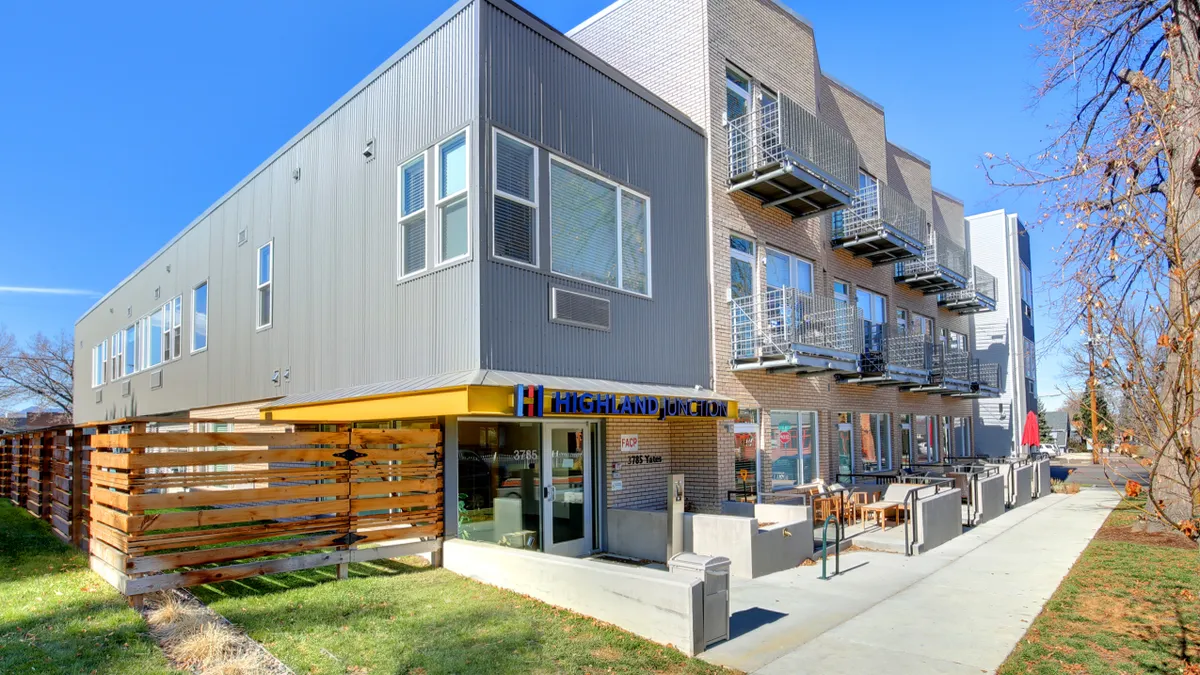 Grey, three-atory apartments with aluminum siding