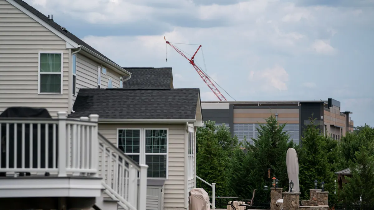 An Amazon Web Services data center is shown situated near single-family homes