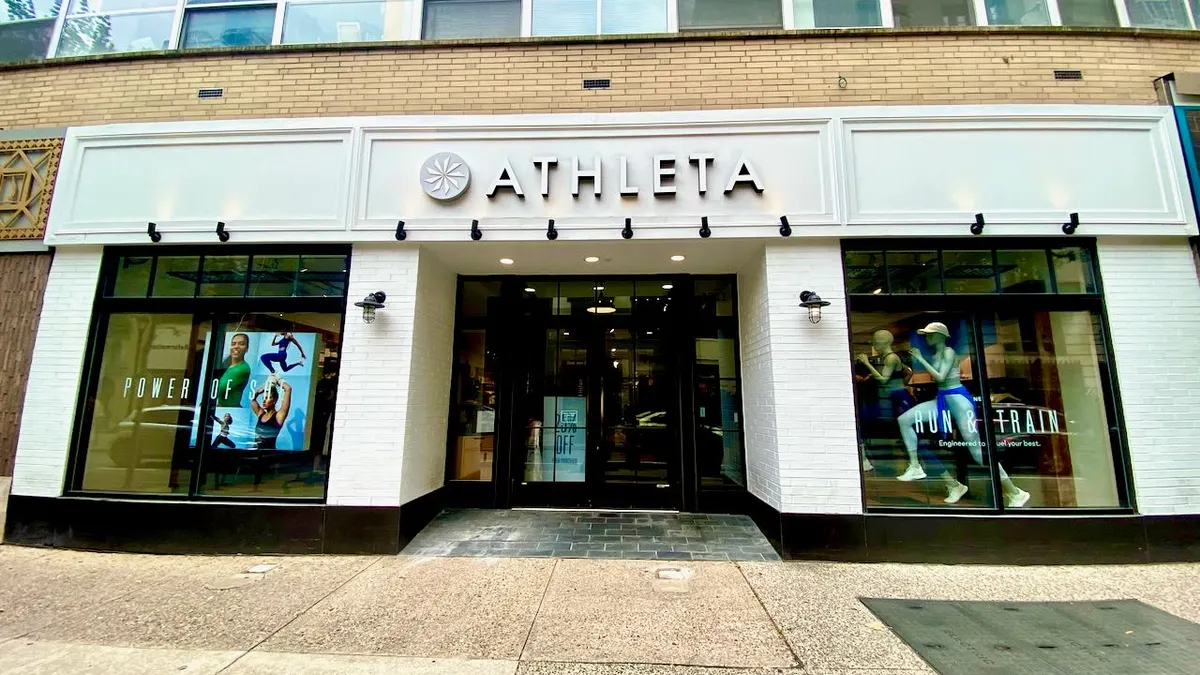 The front door and front windows of an athletic clothing store.
