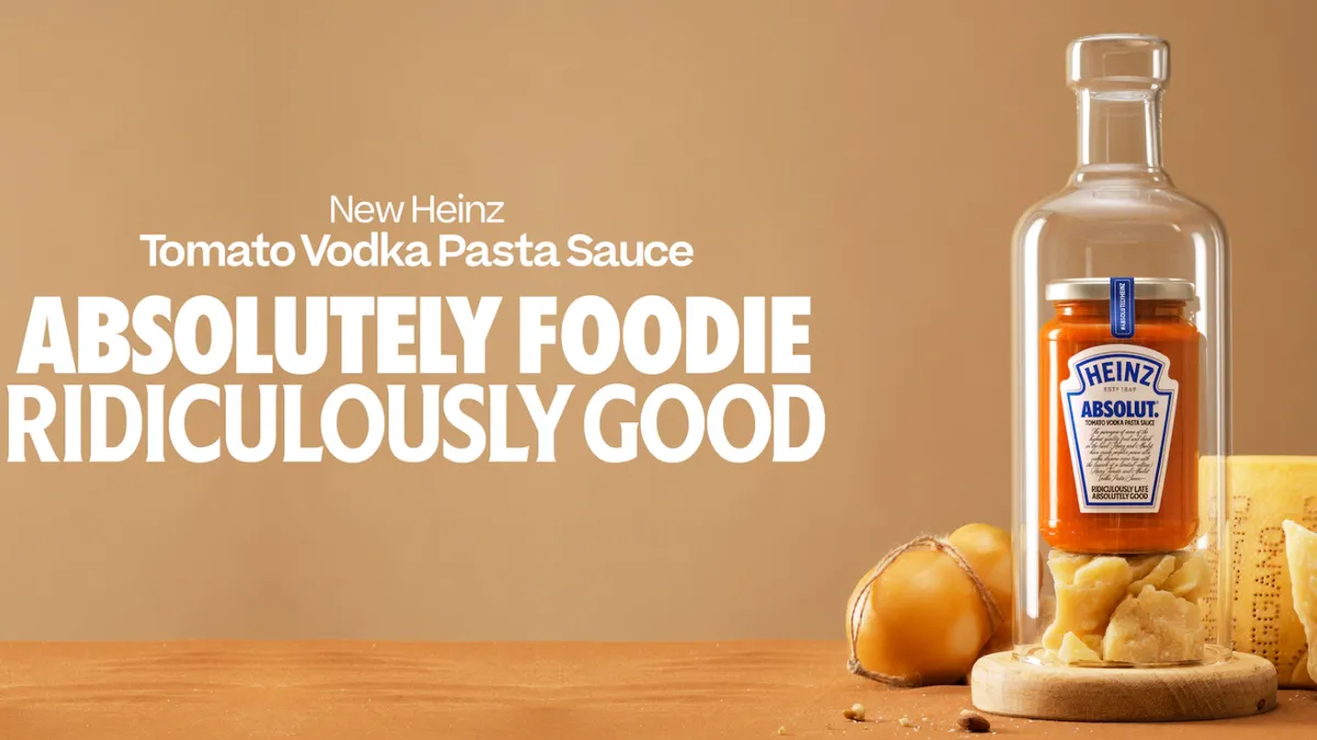 A bottle of Heinz vodka pasta sauce is ensconced in a clear glass bottle with some cheese.