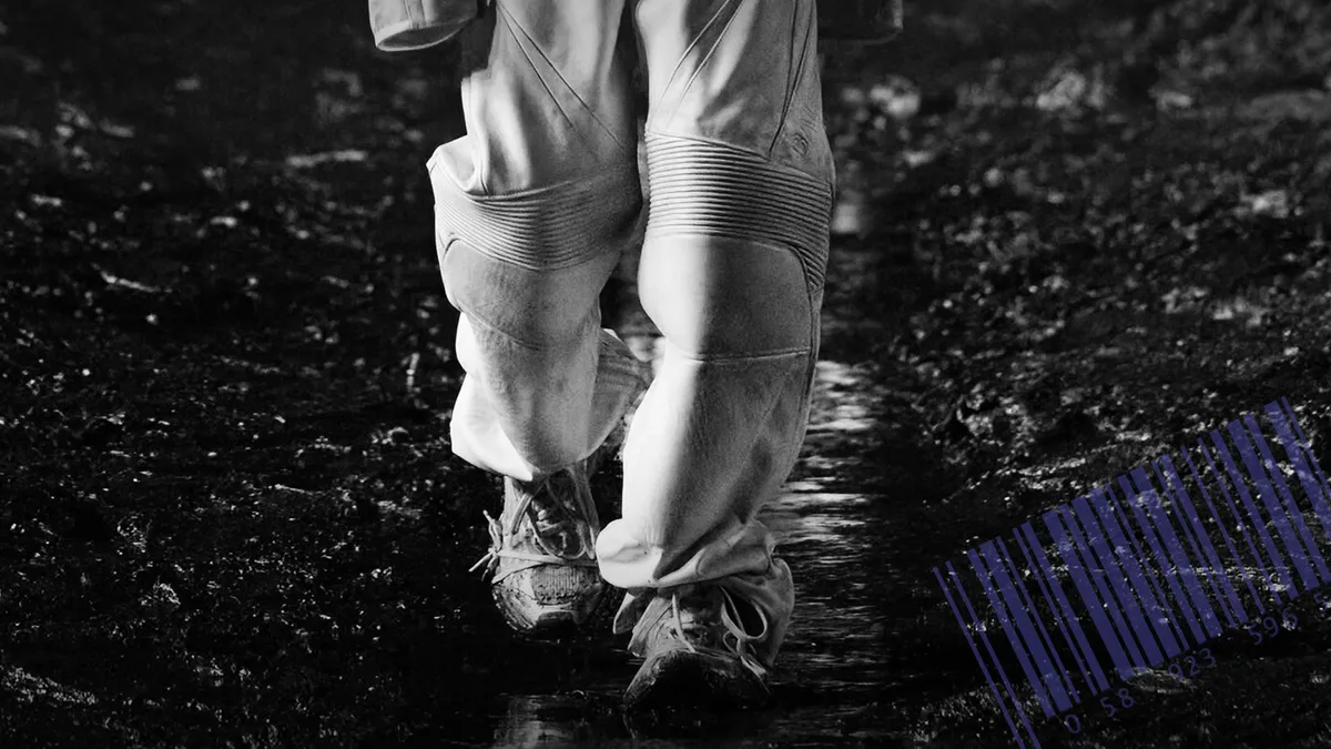 PIcture of a models' legs and feet on a mud runway.