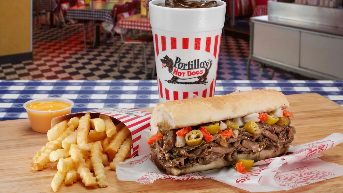 An image of a beef sandwich, fries and a drink with Portillo's branding on it