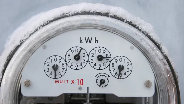 An electricity meter covered in snow.